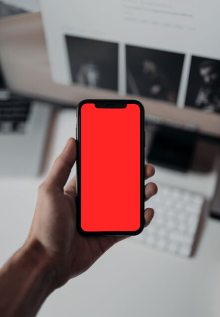 Man Holding An iPhone X XS PSD Mockup